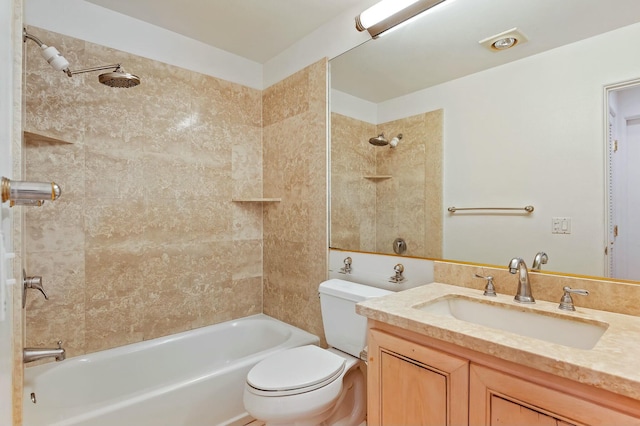 full bathroom with vanity, tiled shower / bath combo, and toilet