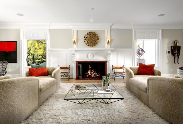 living room featuring crown molding and light hardwood / wood-style flooring