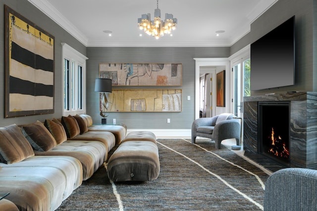 living room with a premium fireplace, crown molding, and a chandelier