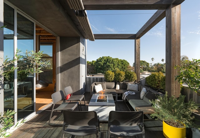 view of patio / terrace with an outdoor living space with a fire pit and a deck