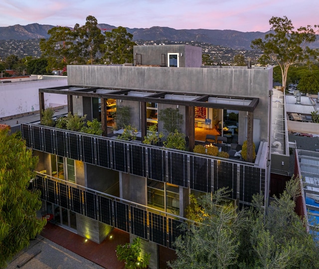 back house at dusk featuring a mountain view