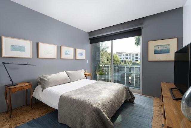 bedroom featuring access to outside and dark hardwood / wood-style flooring