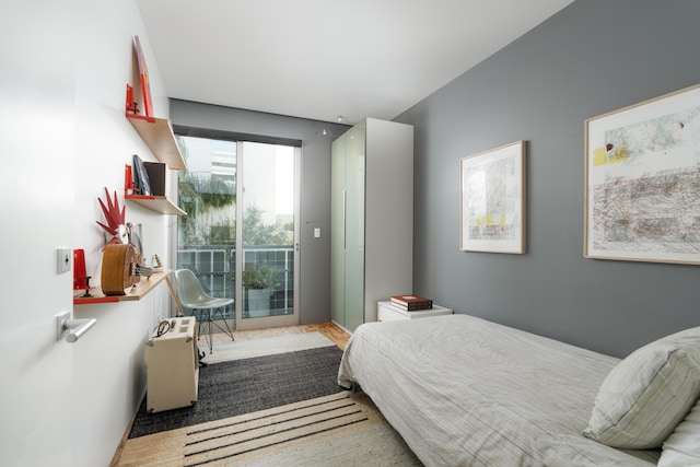 bedroom featuring hardwood / wood-style floors and access to outside