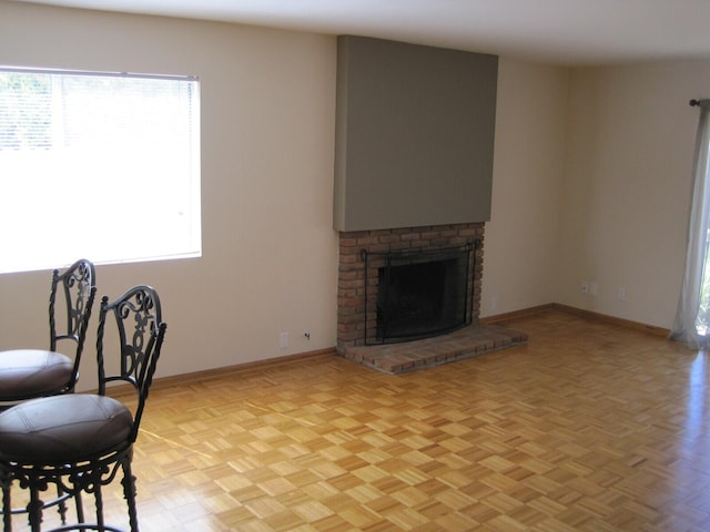 living room with a fireplace and baseboards