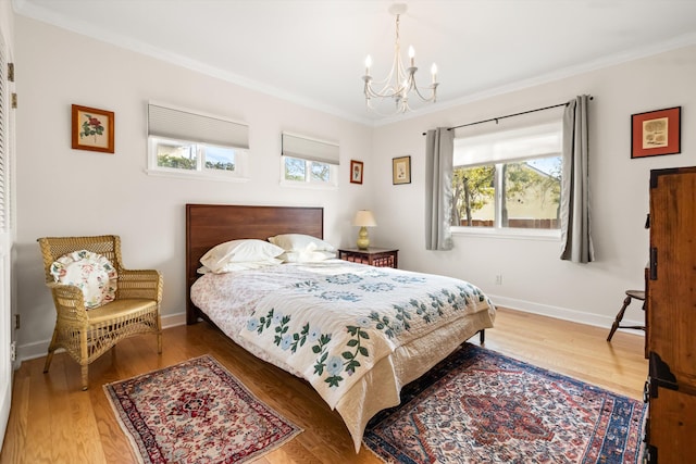 bedroom with ornamental molding, a chandelier, and hardwood / wood-style floors