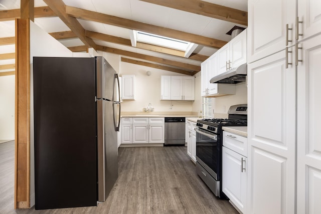 kitchen featuring under cabinet range hood, white cabinetry, stainless steel appliances, and light countertops