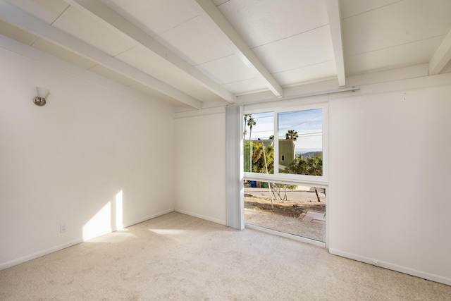 empty room featuring carpet, beamed ceiling, and baseboards