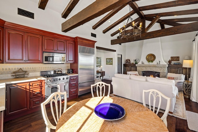 4230 Cresta Ave, Santa Barbara, CA 93110 - dining space featuring dark wood-type flooring, a large fireplace, a chandelier, and high vaulted ceiling