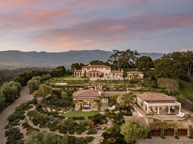 aerial view at dusk featuring a mountain view