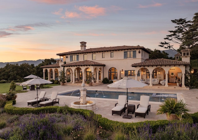 4230 Cresta Ave, Santa Barbara, CA 93110 - back house at dusk featuring a patio and pool water feature