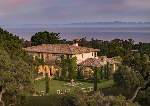 exterior space with a water view, a gazebo, and a lawn