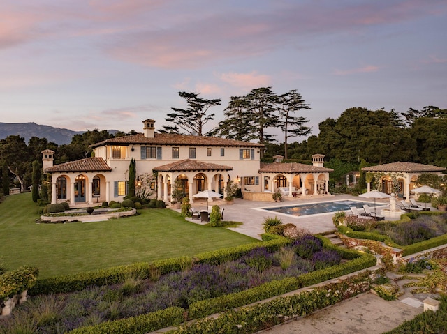 4230 Cresta Ave, Santa Barbara, CA 93110 - back house at dusk with a patio, a gazebo, and a lawn