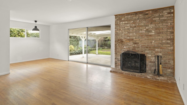 unfurnished living room featuring hardwood / wood-style flooring and a fireplace