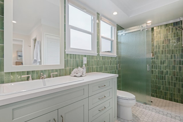 bathroom with tile patterned floors, toilet, tile walls, vanity, and a shower with door