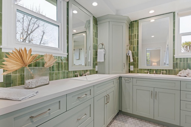 bathroom with tasteful backsplash, vanity, and tile patterned flooring