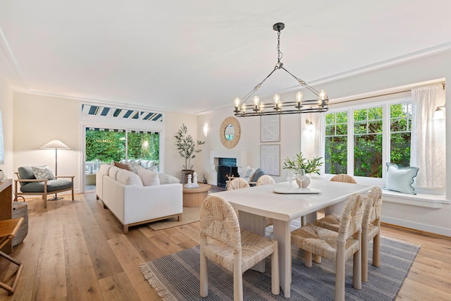 dining area with a chandelier and light hardwood / wood-style floors