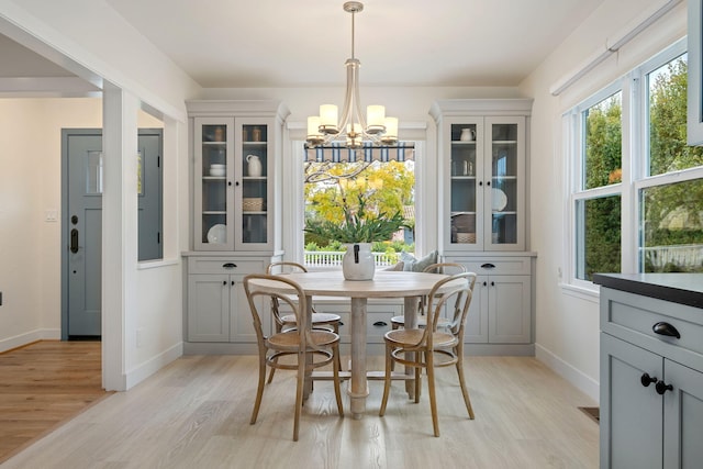 dining space featuring a notable chandelier and light hardwood / wood-style floors