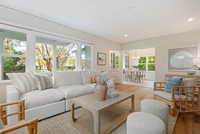 living room featuring an inviting chandelier and light hardwood / wood-style flooring