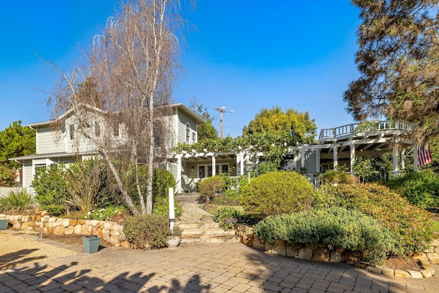 back of property featuring a patio area and a pergola