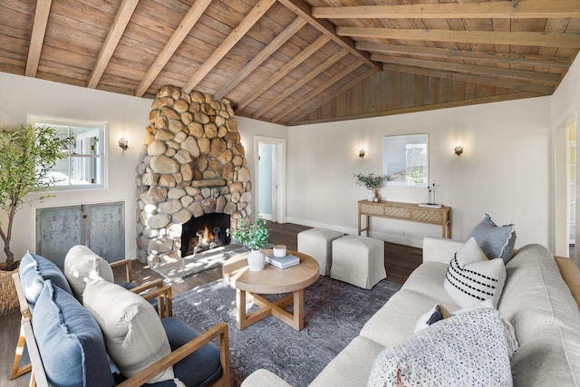 living room featuring dark hardwood / wood-style flooring, vaulted ceiling with beams, plenty of natural light, and a fireplace