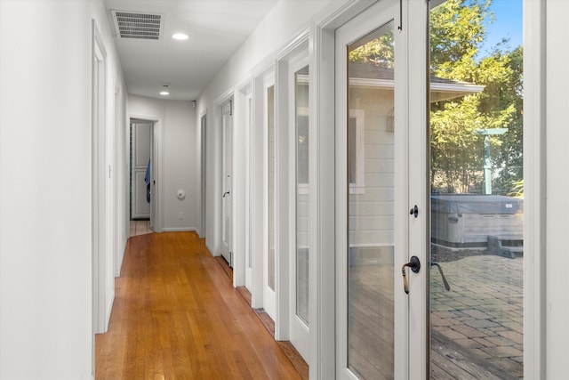 hall with light hardwood / wood-style flooring