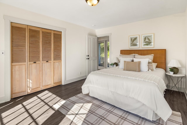 bedroom with dark hardwood / wood-style floors and a closet