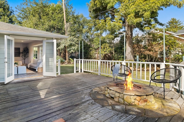 wooden deck with an outdoor fire pit