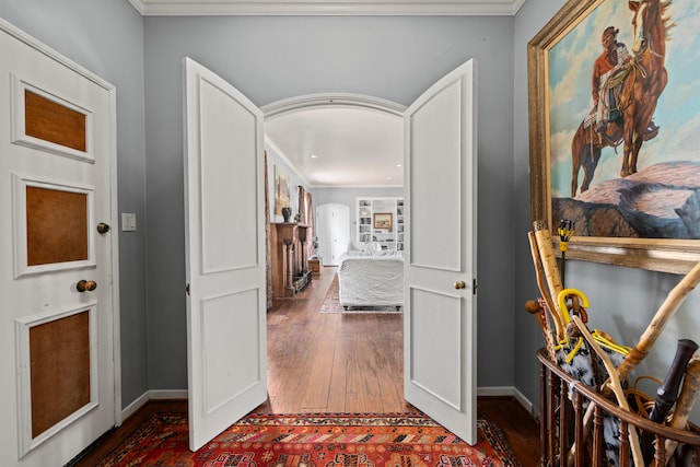 entryway featuring dark wood-type flooring and ornamental molding