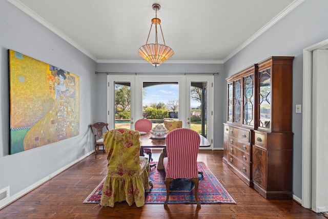 dining space with dark wood-type flooring and ornamental molding