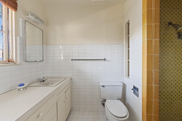 bathroom with tile walls, tile patterned flooring, vanity, a wealth of natural light, and toilet