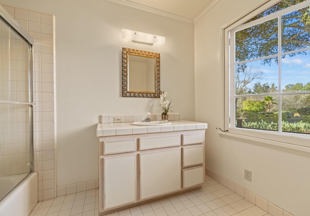 bathroom with vanity, tile patterned floors, ornamental molding, and shower / bath combination with glass door