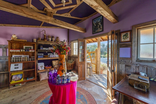 interior space with hardwood / wood-style flooring and beam ceiling