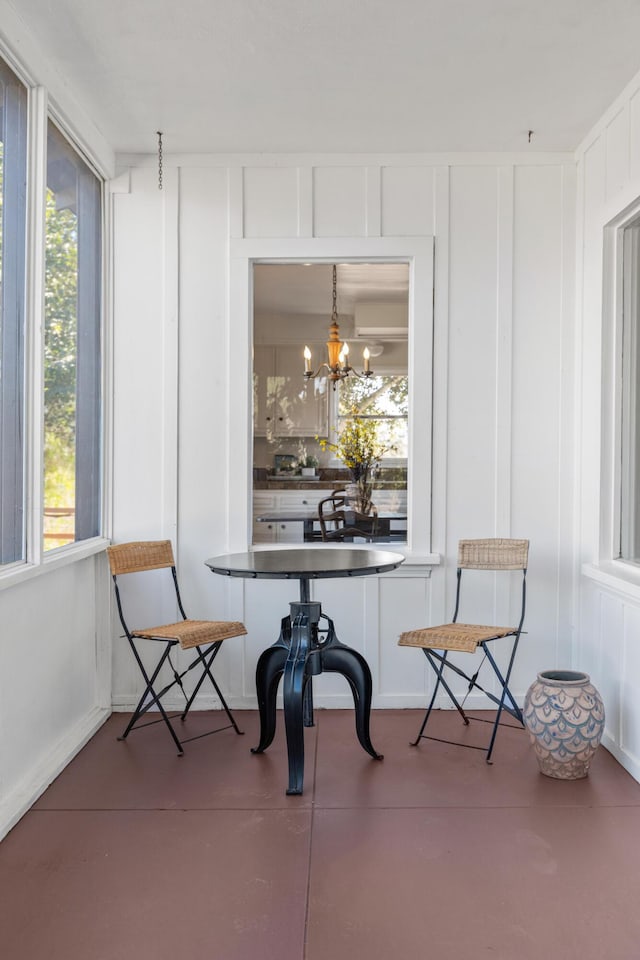 sunroom / solarium featuring an inviting chandelier