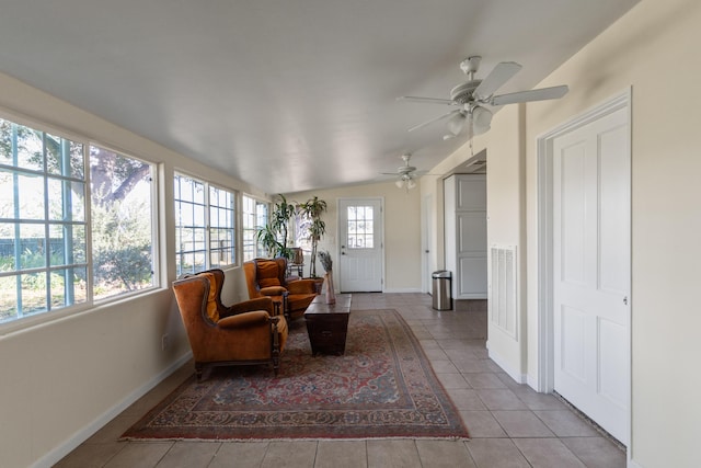 sunroom with ceiling fan and lofted ceiling