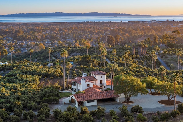 aerial view at dusk with a water and mountain view