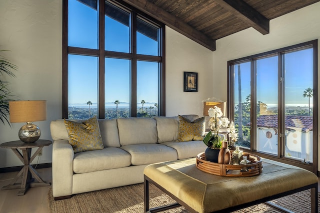 living room with wood ceiling, plenty of natural light, and lofted ceiling with beams