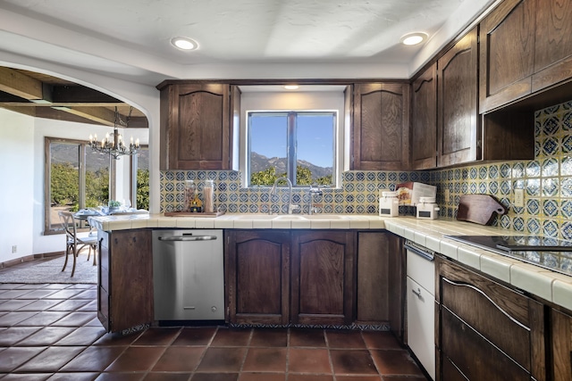 kitchen with tasteful backsplash, dark brown cabinets, stainless steel dishwasher, and tile countertops