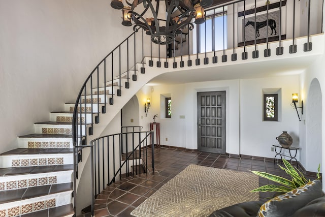 tiled entryway featuring a high ceiling and a wealth of natural light