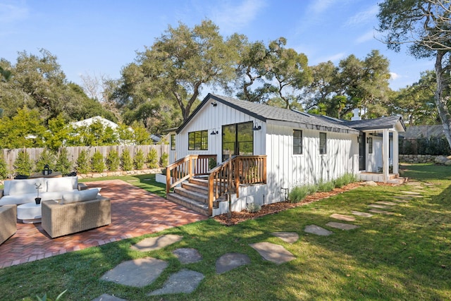 back of property with a patio, outdoor lounge area, and a yard