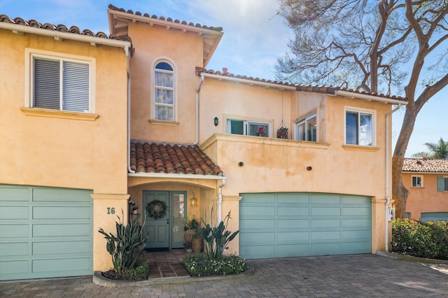 mediterranean / spanish home featuring a garage