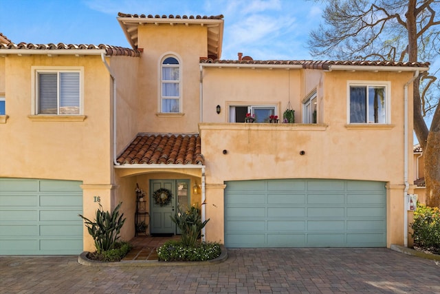 mediterranean / spanish-style house with a garage