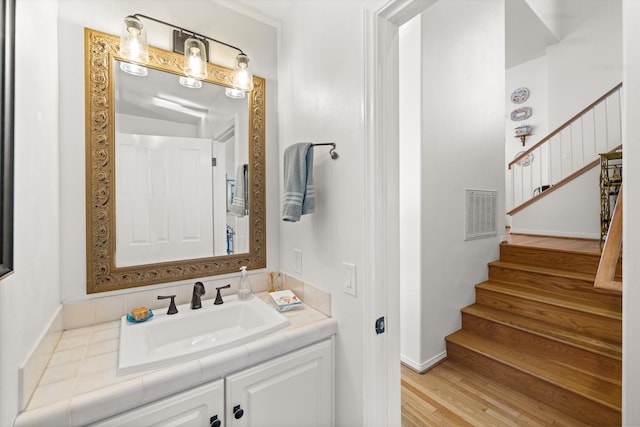 bathroom featuring hardwood / wood-style flooring and vanity