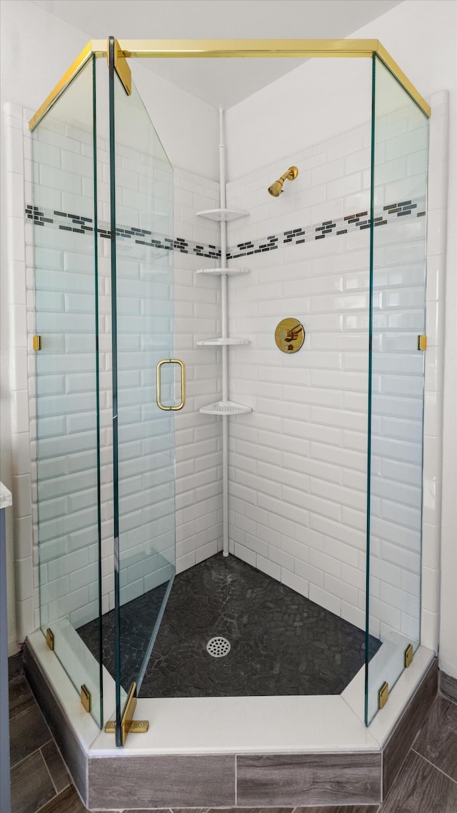 bathroom with a shower with door