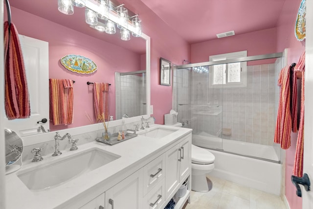 full bathroom featuring toilet, tile patterned floors, shower / bath combination with glass door, and vanity