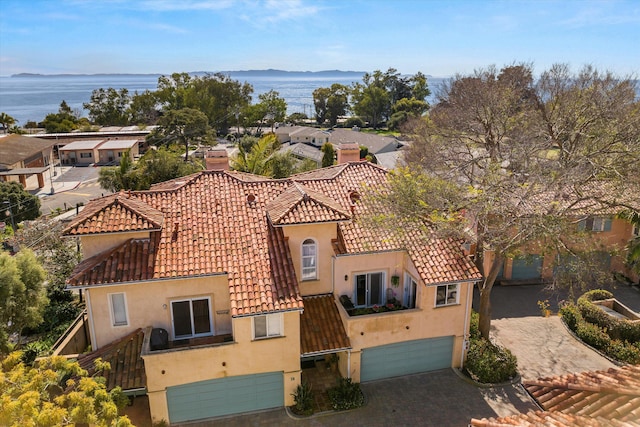 birds eye view of property with a water view