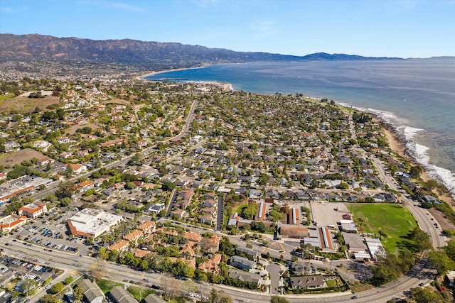 birds eye view of property with a water and mountain view