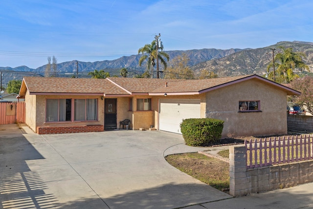 ranch-style house with a garage and a mountain view