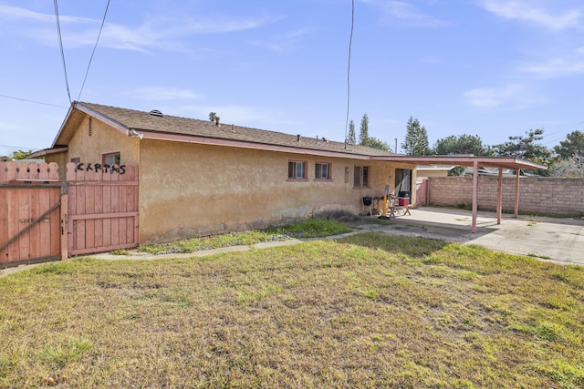 back of house featuring a yard and a patio area