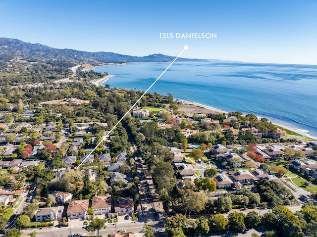 drone / aerial view featuring a water and mountain view