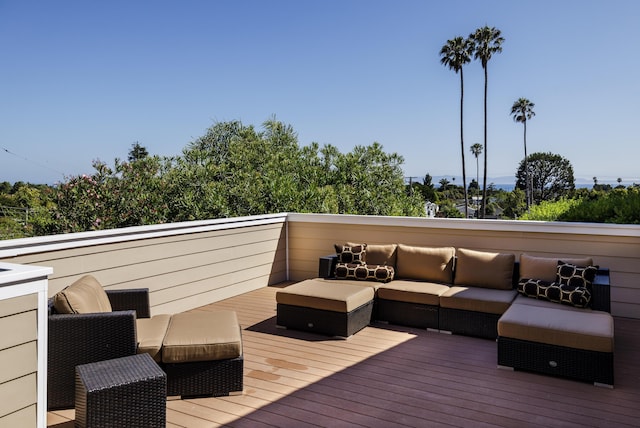 wooden deck with an outdoor living space